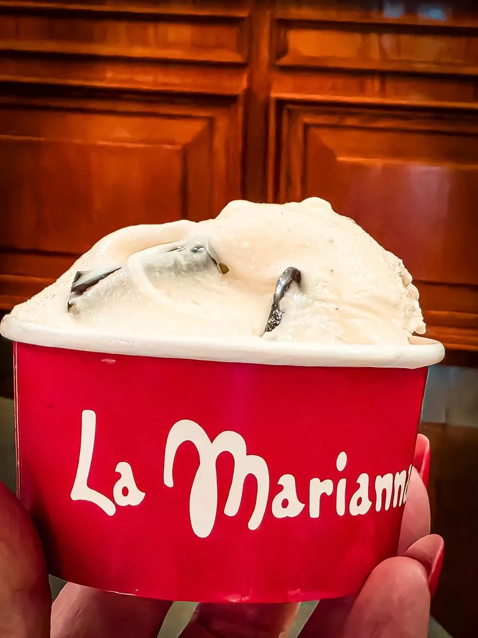 Lody stracciatella z kawałkami czekolady w czerwonym kubeczku lodziarni La Marianna w Bergamo
